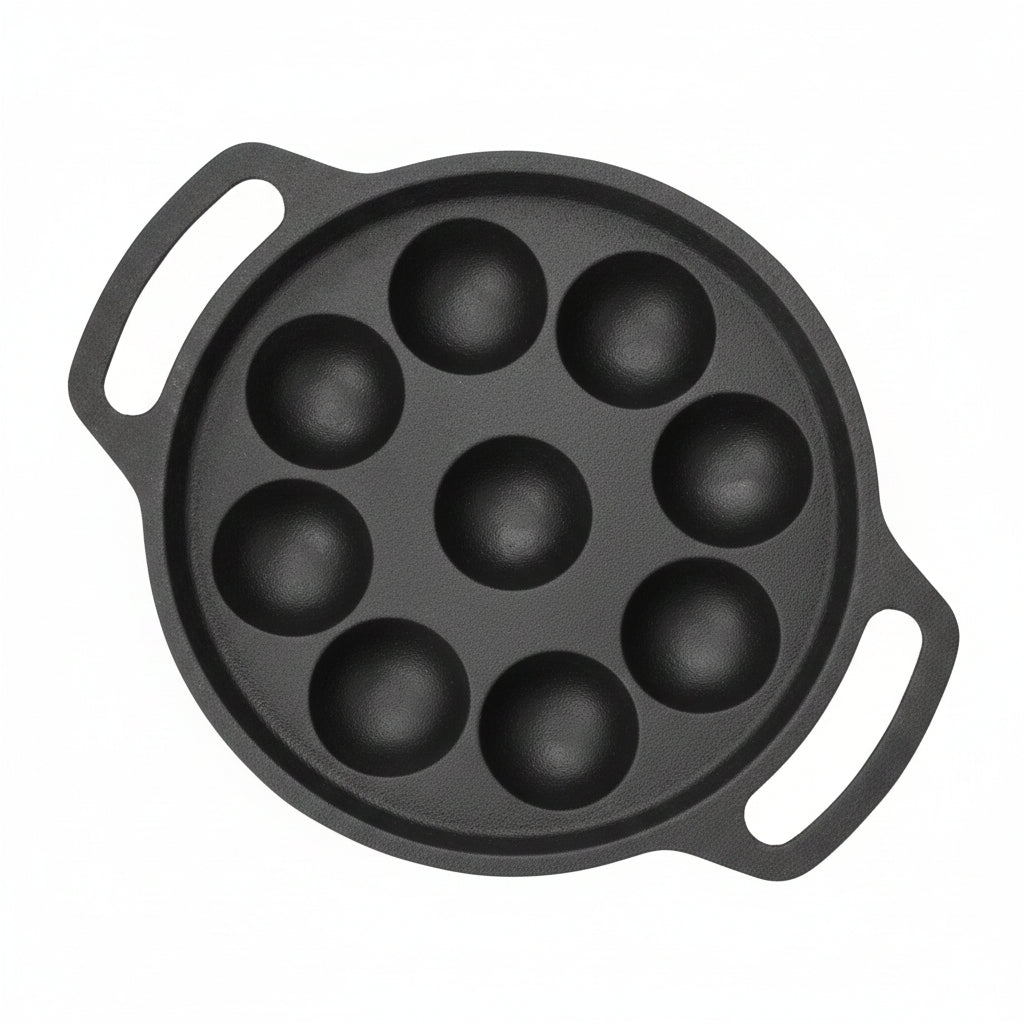 A dark gray cast iron pan with seven deep round domed cavities and two side handles, shown on a plain light gray background.